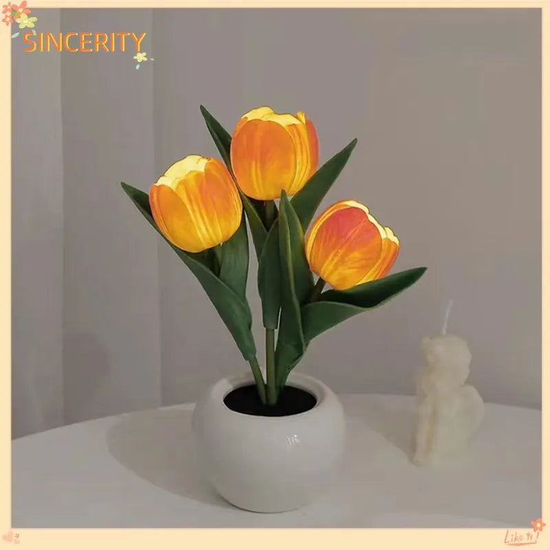 Orange LED tulip lamp with three glowing flower heads in a round white base