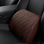 Close-up of the brown lumbar cushion against the seat, showing the chevron-quilted face and smooth border.