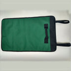 Green canvas tool bag laid flat, outer face up, with black edge binding and two black tie straps.