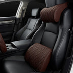 Tighter crop of the driver's seat with the brown neck pillow and lumbar cushion in place.