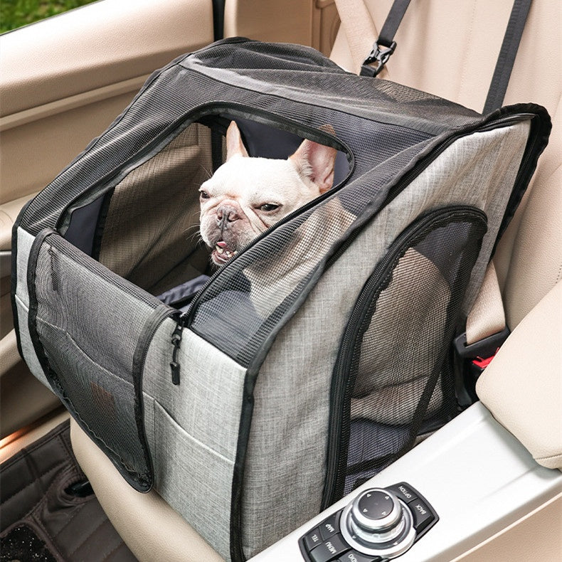 Gray dog car crate on the front passenger seat with a French bulldog inside