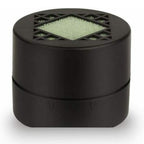 White-background product photo of the black cylindrical filter, its top grille revealing pale green media.