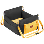 Black dog booster car seat from the side, showing the side pocket and adjustable headrest strap