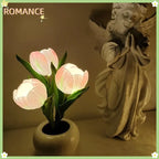 Pink LED tulip lamp with three glowing flower heads in a round white base