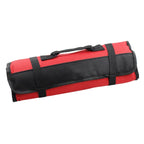 White-background photo of the rolled red tool bag showing its black carry handle and securing straps.