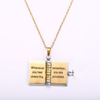 White-background shot of the locket opened flat, its two gold pages engraved with the message about being priceless.