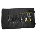 The black roll-up tool bag unrolled and loaded with wrenches, pliers and a screwdriver.