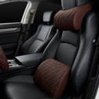 Brown quilted neck pillow and lumbar cushion fitted to the front seats of a car, both seats in view.