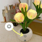 The power button on the base of the tulip lamp, held down to dim the light