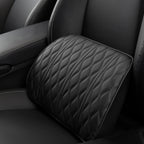 Close-up of the black lumbar cushion resting against the seat back, showing its diamond-quilted face.