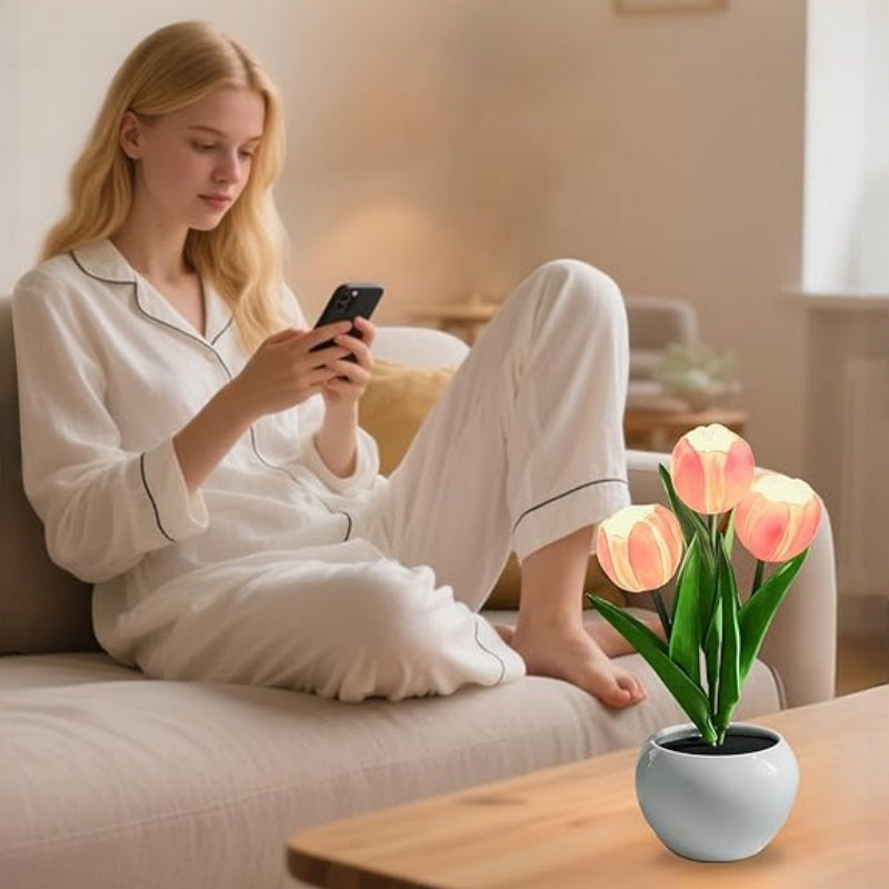 The tulip lamp lighting a coffee table while someone relaxes on the sofa behind it