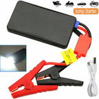 Black jump starter power bank with clamps, a USB cable and an inset showing its flashlight beam