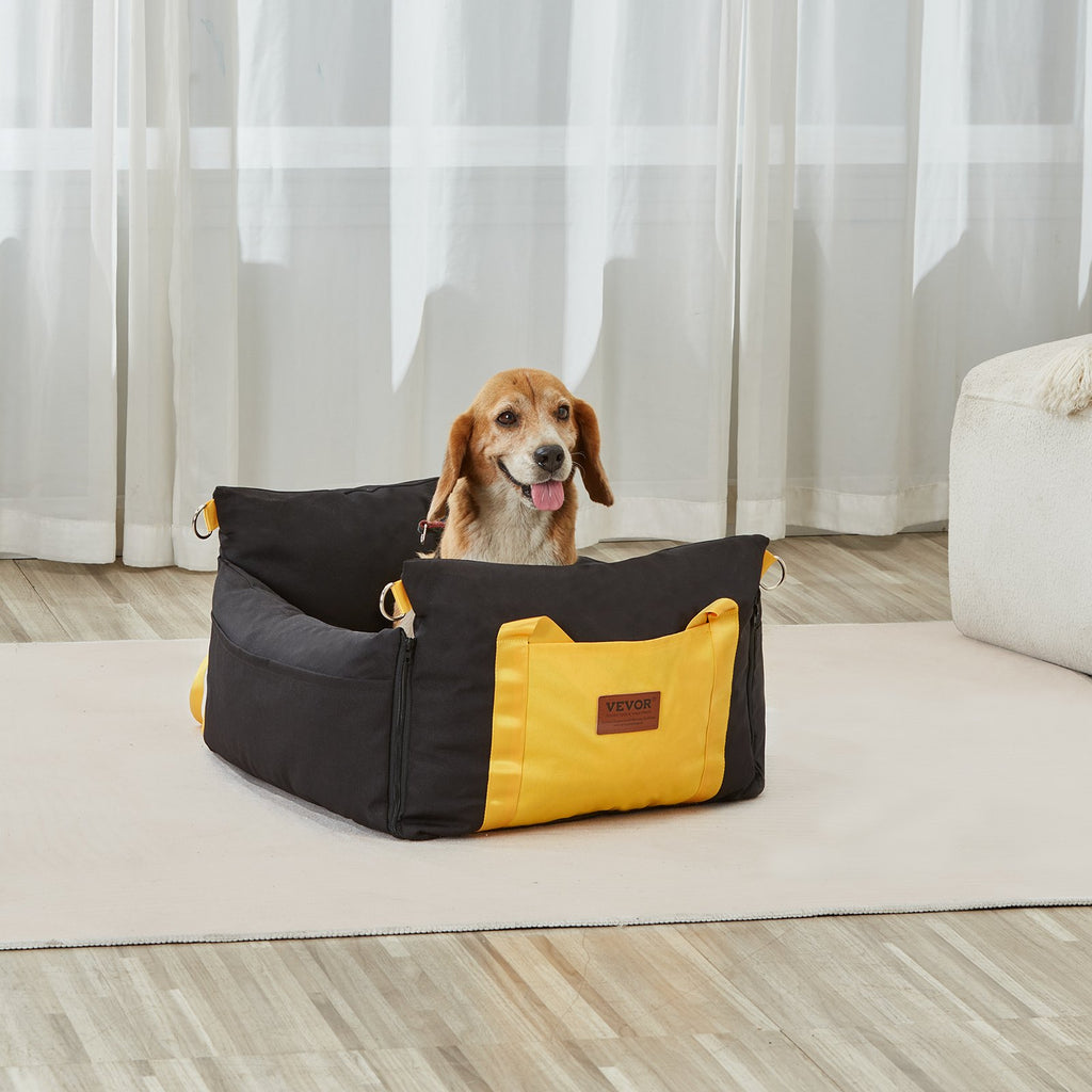 A beagle sitting inside the black and yellow booster seat in a living room